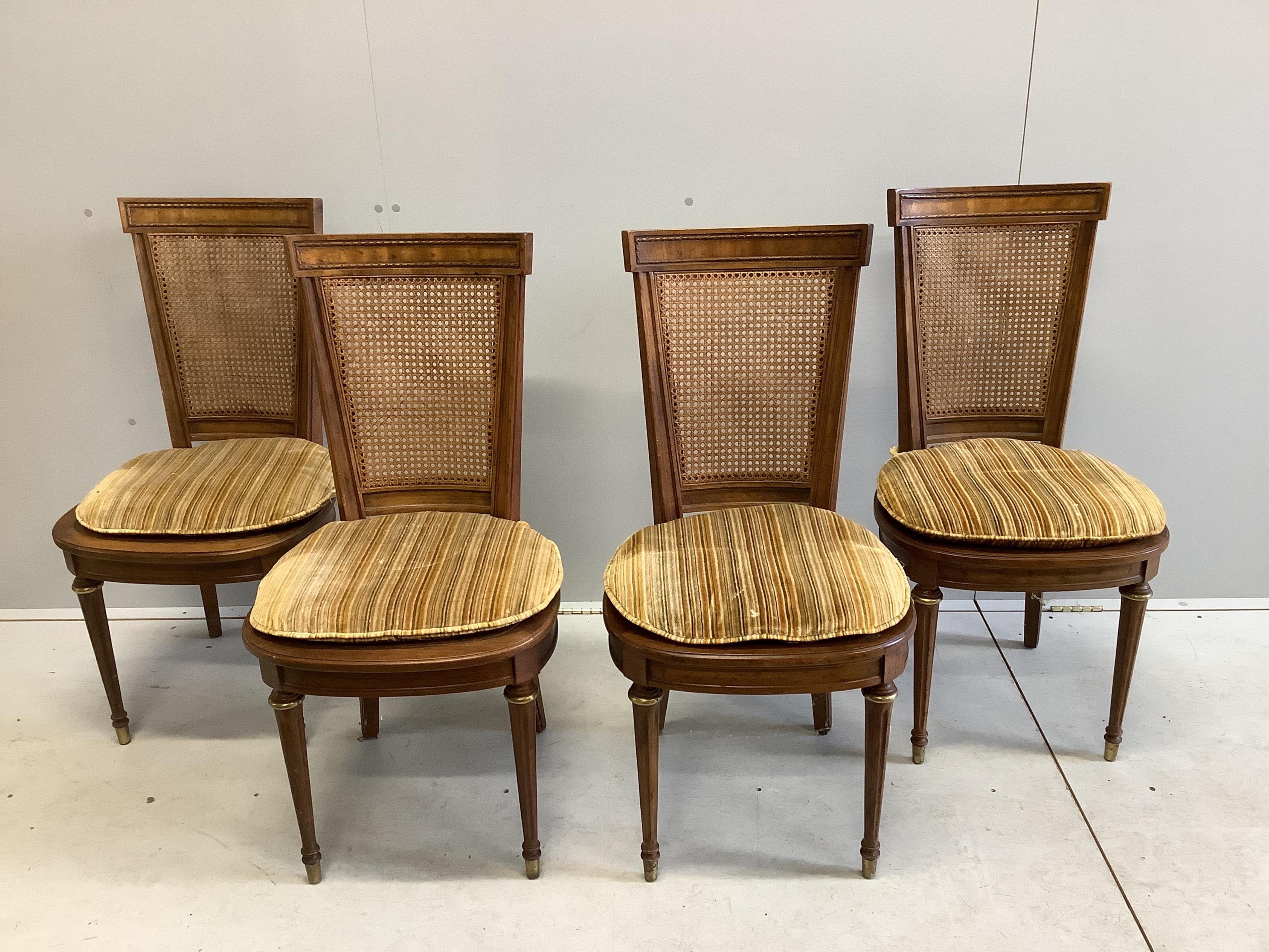 An Empire style circular mahogany games table, diameter 92cm, height 74cm and four caned chairs. Condition - fair to good